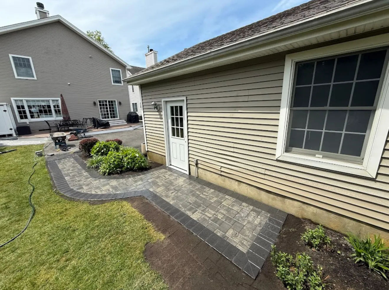 Custom paver patio landscaping project in Carver, MN by Hartley Lawn & Landscape