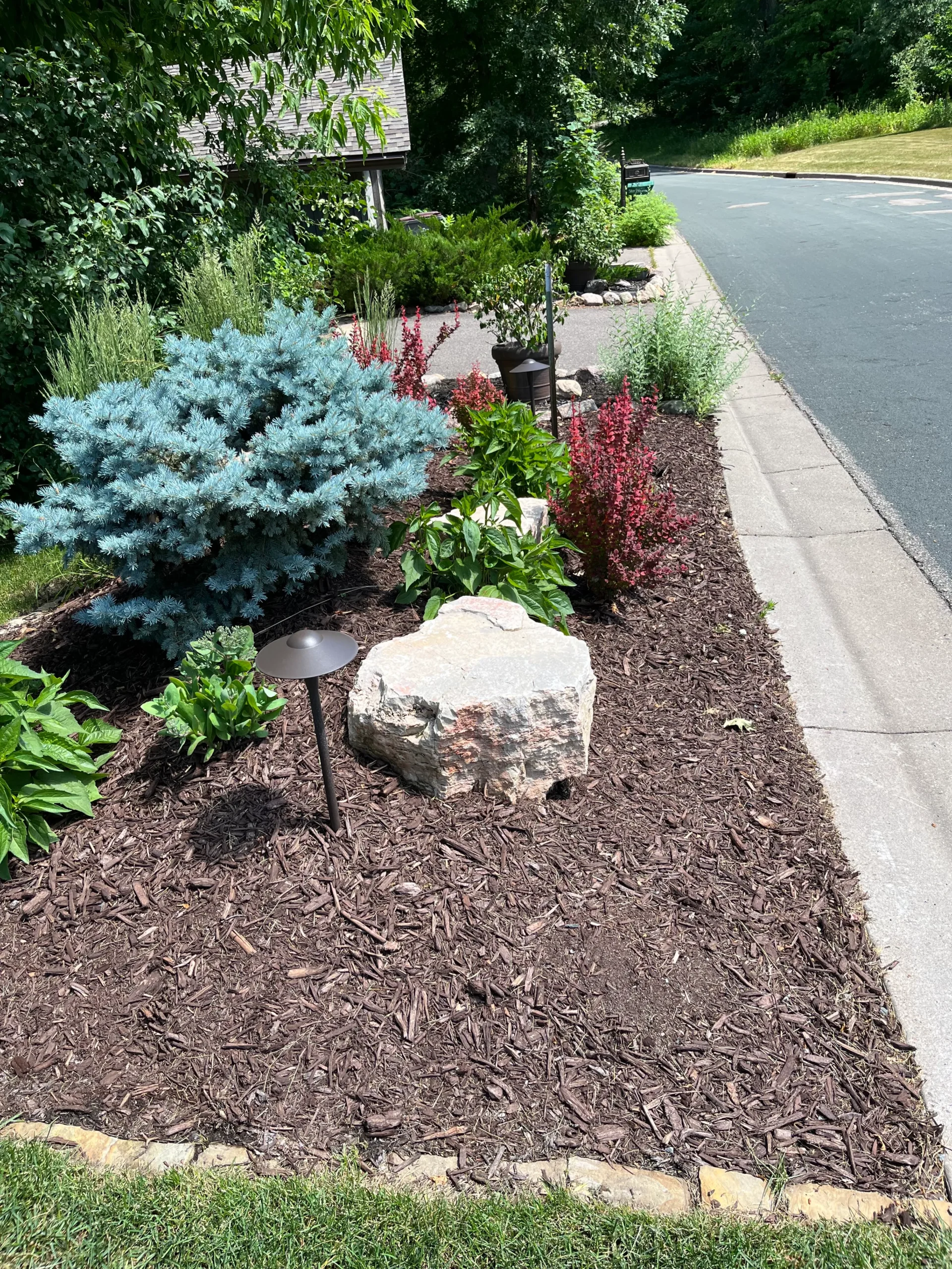 Fresh bark mulch applied around a garden bed in Scott County, MN